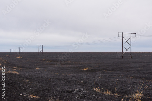 Fotografija power lines leading in the volcanic sand desert, Iceland