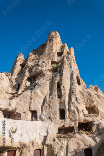 A detail from the Monastery of nuns in Cappadocia. Impressive fairy chimneys of sandstone in the canyon near Cavusin village, Cappadocia, Nevsehir Province in the Central Anatolia Region of Turkey. 