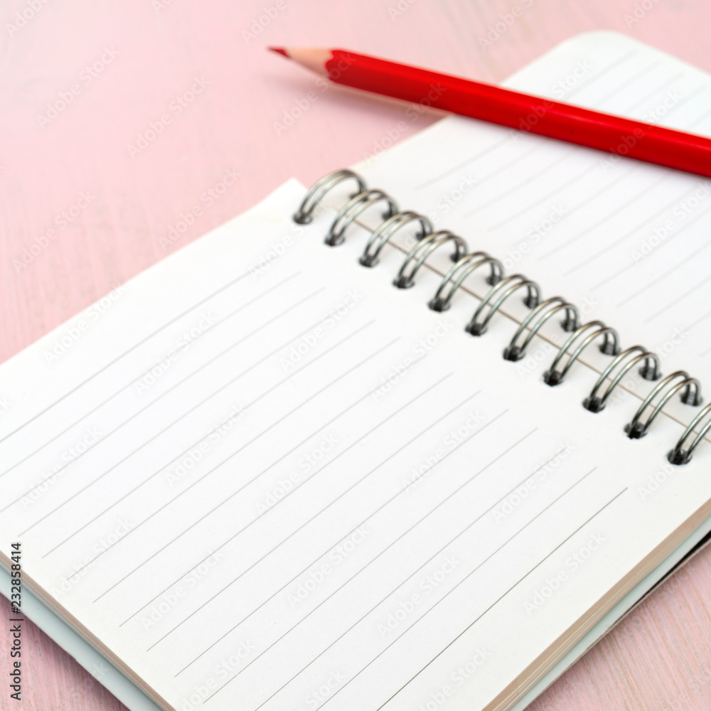 Red pencil and notebook for notes. Red pencil and notebook for notes.