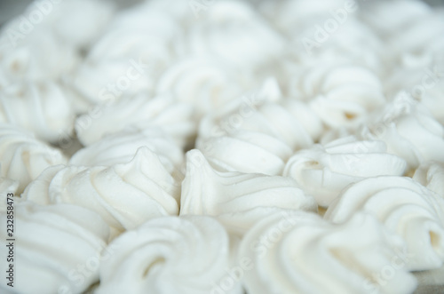Closeup of meringue cookies on a blue tablecloth
