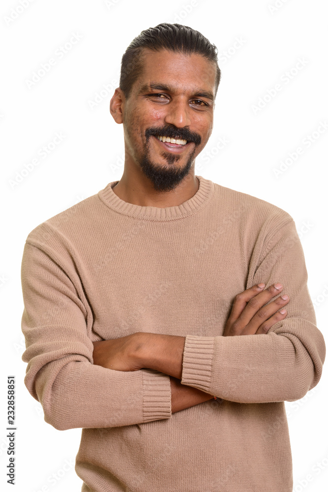 Fototapeta premium Young happy Indian man smiling with arms crossed