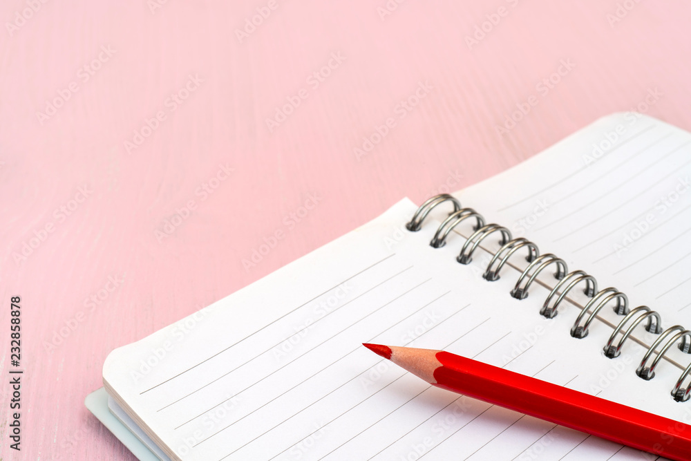 Red pencil and notebook for notes.