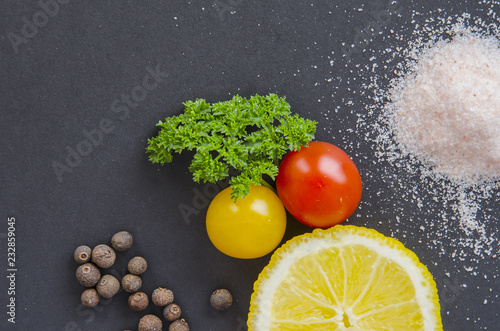 Fresh delicious ingredients for healthy cooking or salad making on dark black background, top view, banner