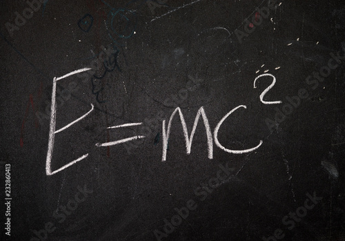 formula e=mc2 written in chalk on the blackboard