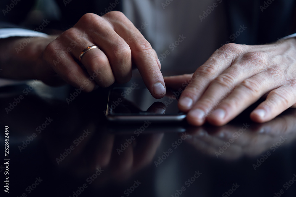 close up of a business man using a mobile phone