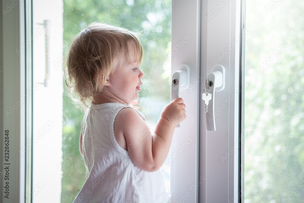 Child on window sill on high floor
