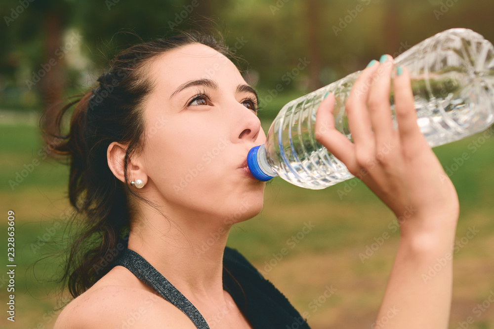 Portrait of sportswoman drinking water after workout Portrait of sportswoman drinking water after workout