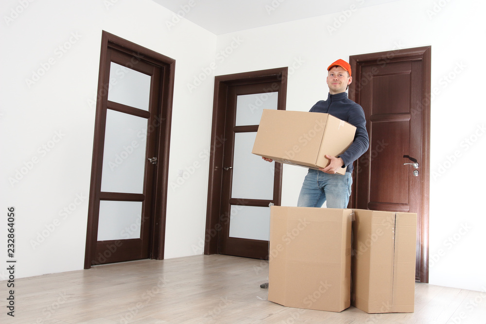 Mover with cardboard boxes in house