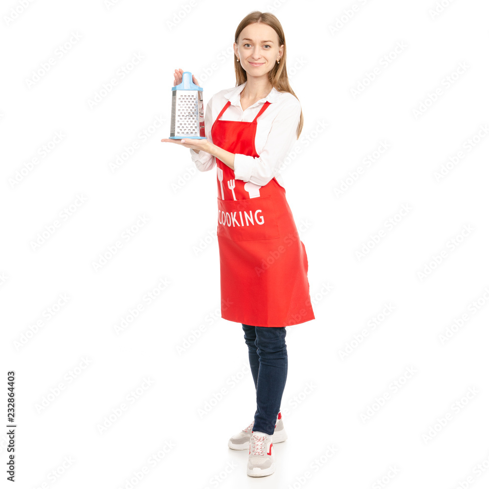 A woman in a red apron in the hands kitchen grater on a white background. Isolation A woman in a red apron in the hands kitchen grater on a white background. Isolation