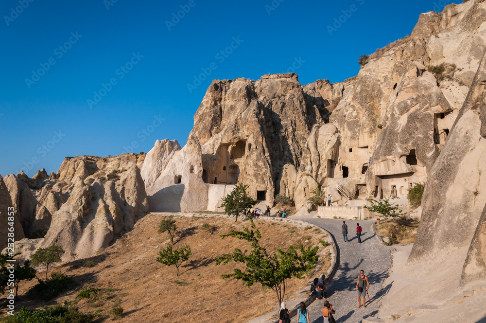 A detail from the structure of Cappadocia. Impressive fairy chimneys of sandstone in the canyon near Cavusin village, Cappadocia, Nevsehir Province in the Central Anatolia Region of Turkey. Clear sky. A detail from the structure of Cappadocia. Impressive fairy chimneys of sandstone in the canyon near Cavusin village, Cappadocia, Nevsehir Province in the Central Anatolia Region of Turkey. Clear sky.