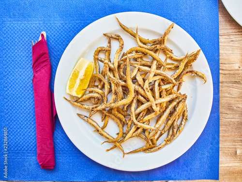 Pescaito frito, fried fish Andalusian style on a tavern table. photo
