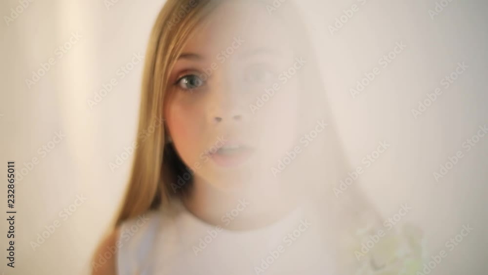 Serious face young blonde girl makes an angry face talk speak white background sad child cute fashion little moody playful studio expression kids portrait slow motion Serious face young blonde girl makes an angry face talk speak white background sad child cute fashion little moody playful studio expression kids portrait slow motion