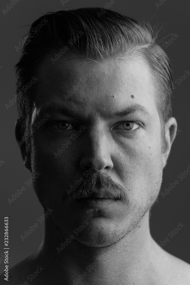 Obraz premium Face of young Caucasian man with mustache shirtless