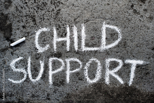 Colorful chalk drawing on asphalt: words CHILD SUPPORT.