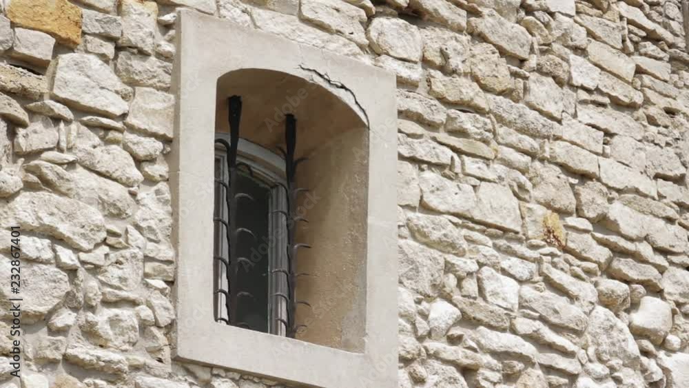 Slow motion the window of an old in a stone house conceptual blockhouse cold frame frost glass outdoor strong close up