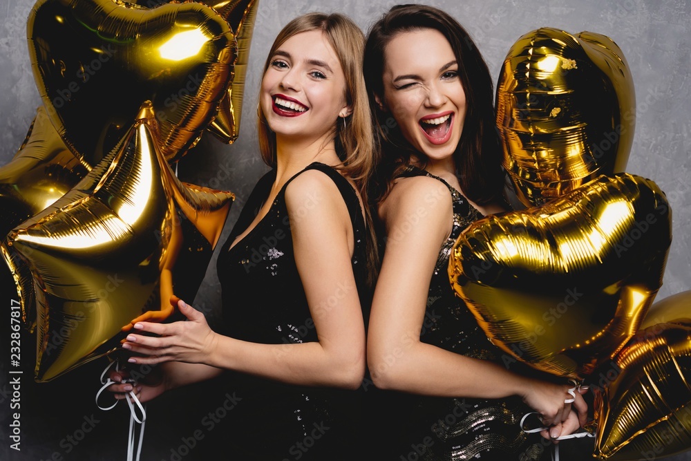Fototapeta premium Party Fun. Beautiful Girls Celebrating New Year. Portrait Of Gorgeous Smiling Young Women Enjoying Party Celebration, Having Fun Together. High Quality Image.