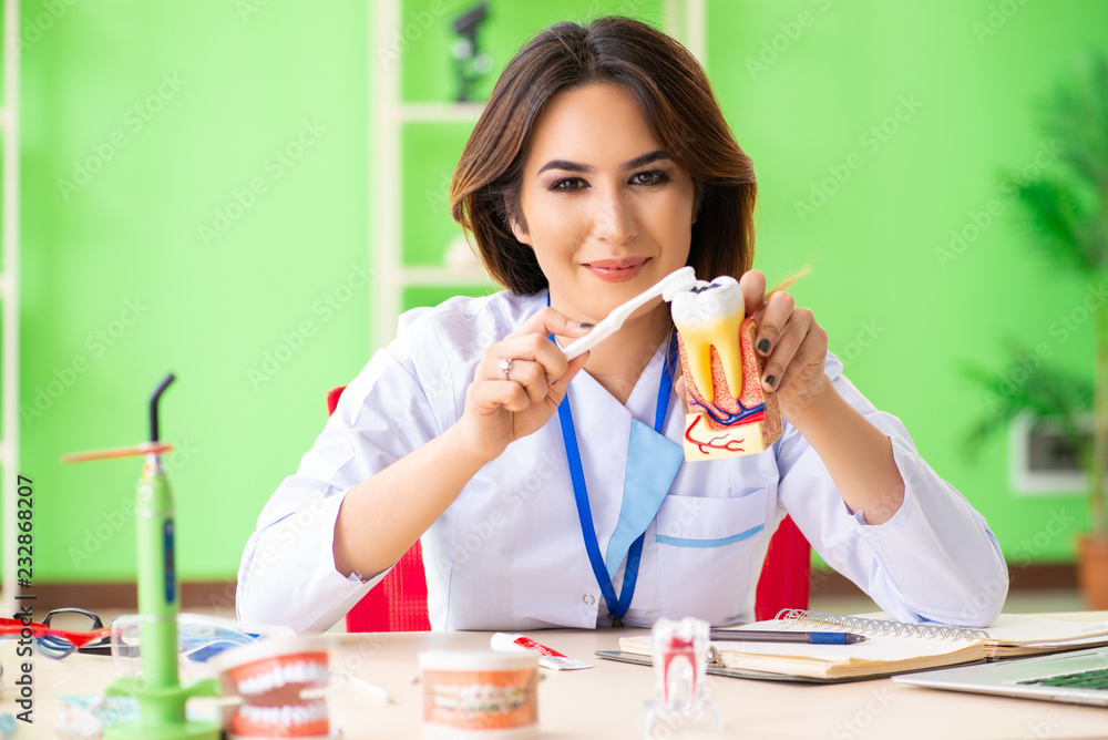 Woman dentist working on teeth implant Woman dentist working on teeth implant