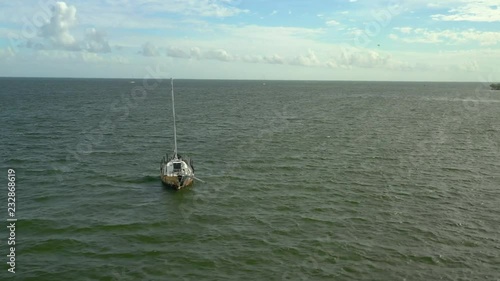 Aerial drone footage of an old sail boat in Miami Biscayne Bay photo