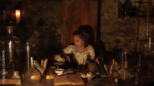 Wallpaper Mural Young beautiful girl sitting on wooden porch in dark room palace light lamp carnival castle closeup costume curly cute dress entertainment expressive face Torontodigital.ca