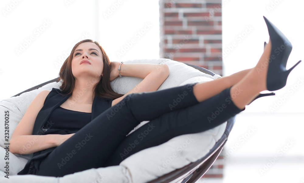 elegant business woman sitting in a comfortable chair.