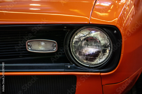 orange car headlight detail © Alex