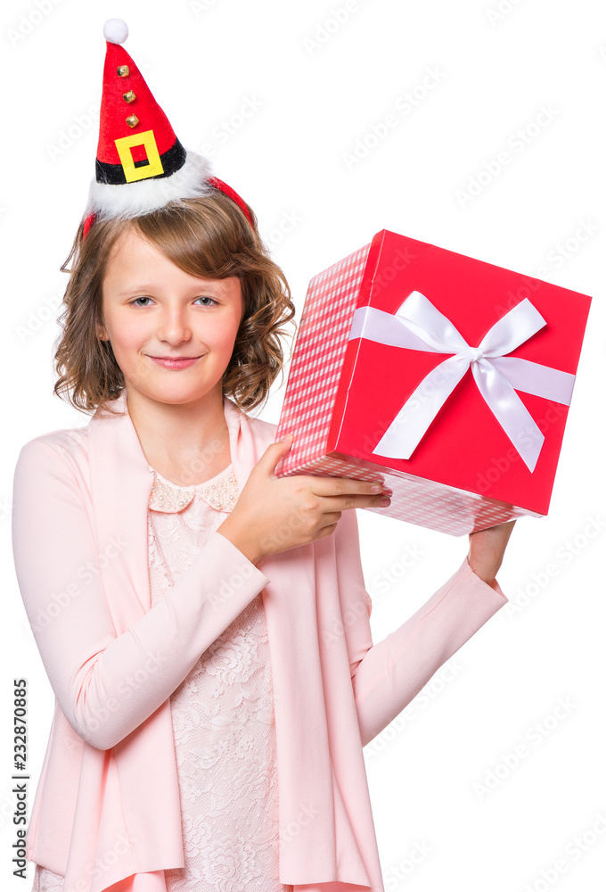 Portrait of happy little girl with Santa Claus hat. Holiday Christmas concept - smiling cute child holding gift box, isolated on white background.