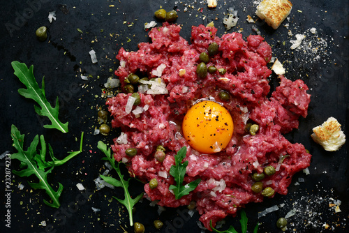 Beef tartare - traditional dish of french cuisine.Top view. photo