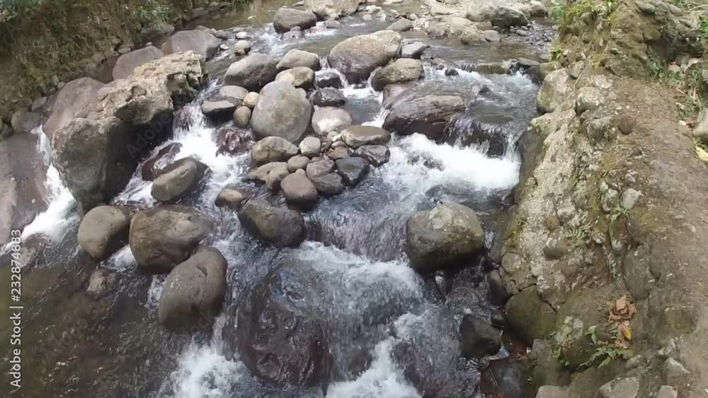 serene scenic view of clear mountain river replete with green vegetation serene scenic view of clear mountain river replete with green vegetation