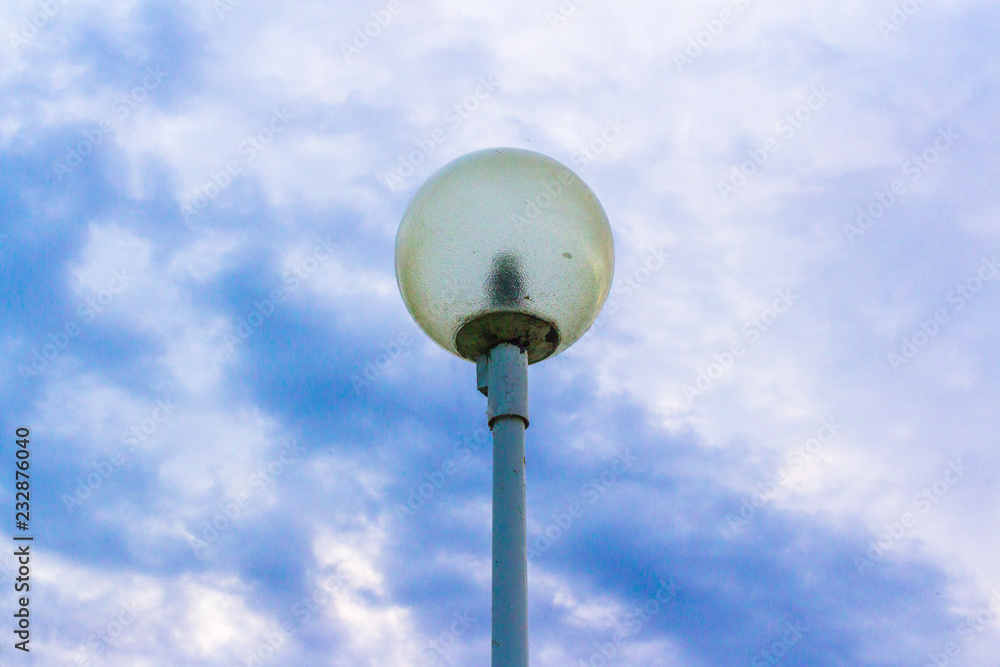 Street lamp against the background of the river and sky Street lamp against the background of the river and sky