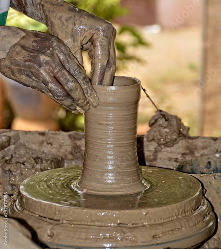 Potter busy making a pot. Potter works with clay by hands. Handmade terracotta pot. Craftsmanship. Close up