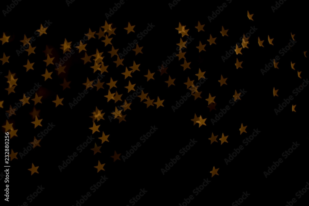 String lights shaped like stars. Defocused festive background. String lights shaped like stars. Defocused festive background.