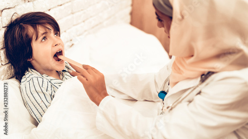 Muslim Pediatrician Examining Boy  Throat Sick