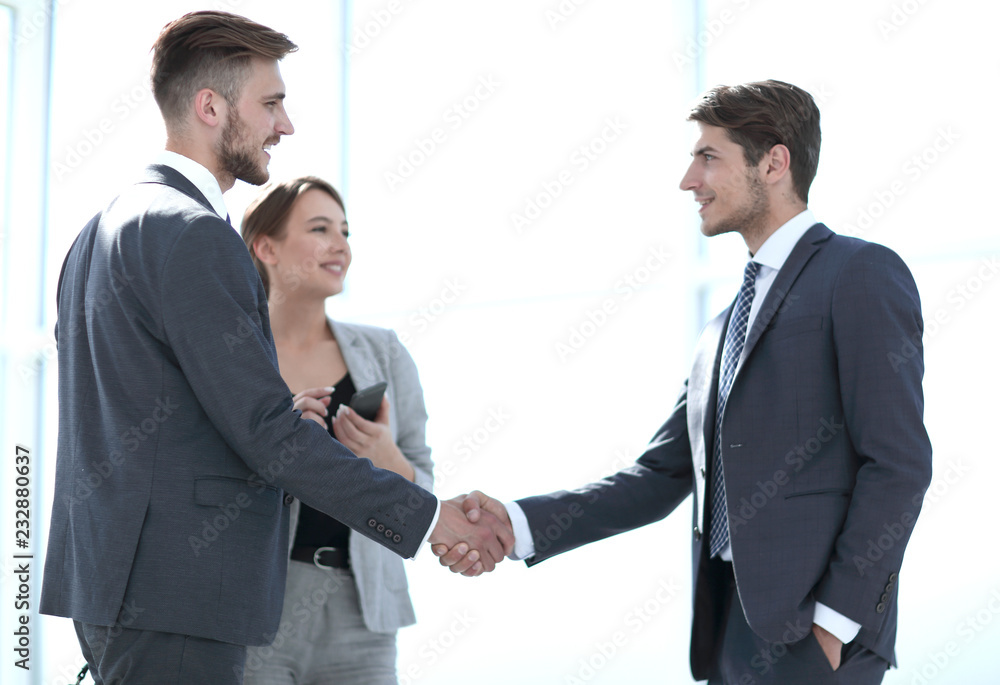 handshake of business partners in a bright office handshake of business partners in a bright office