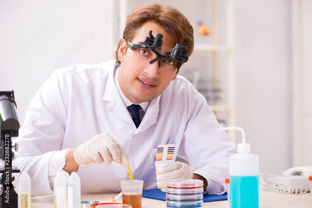 Chemist in the lab checking with ph strips Chemist in the lab checking with ph strips
