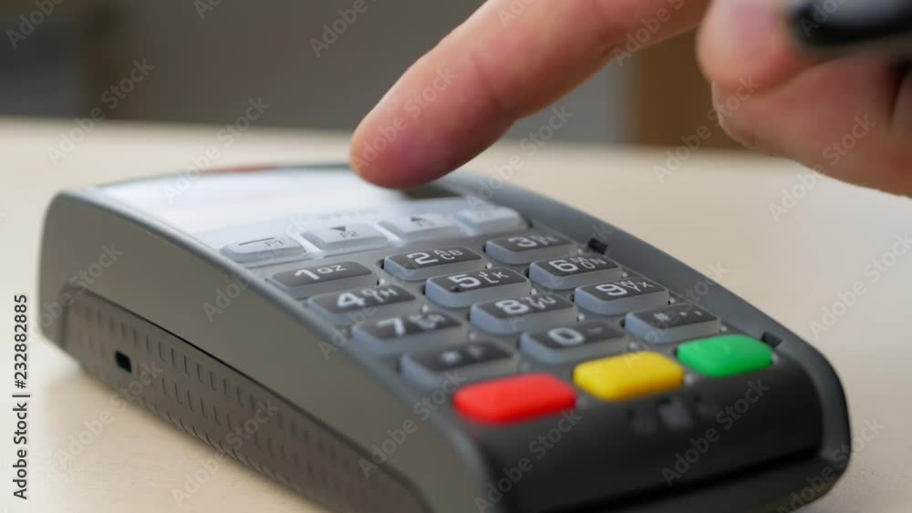 Making Nfc Payment By Mobile Phone with Digital Credit Card at Table. Finger entering the PIN code Making Nfc Payment By Mobile Phone with Digital Credit Card at Table. Finger entering the PIN code