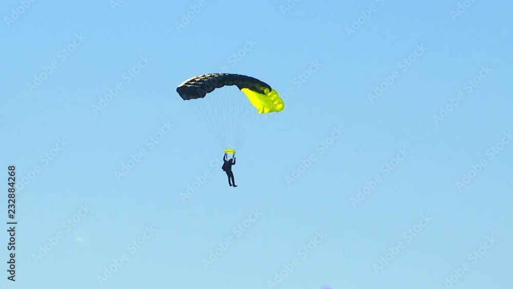 Athletes parachute from an airplane flying high in the sky. Athletes parachute from an airplane flying high in the sky.