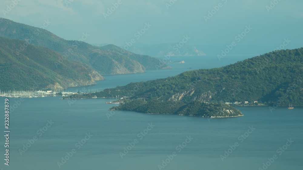 Overgrown mountains on the islands. Seascape background. water surface in a bay