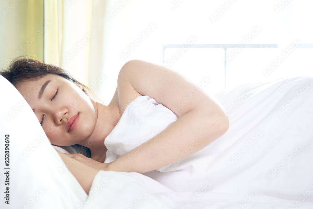Asian women deeply sleeping on comfortable bed in hotel close up. Asian women deeply sleeping on comfortable bed in hotel close up.