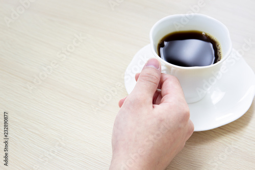 Black coffee in a white cup close up.