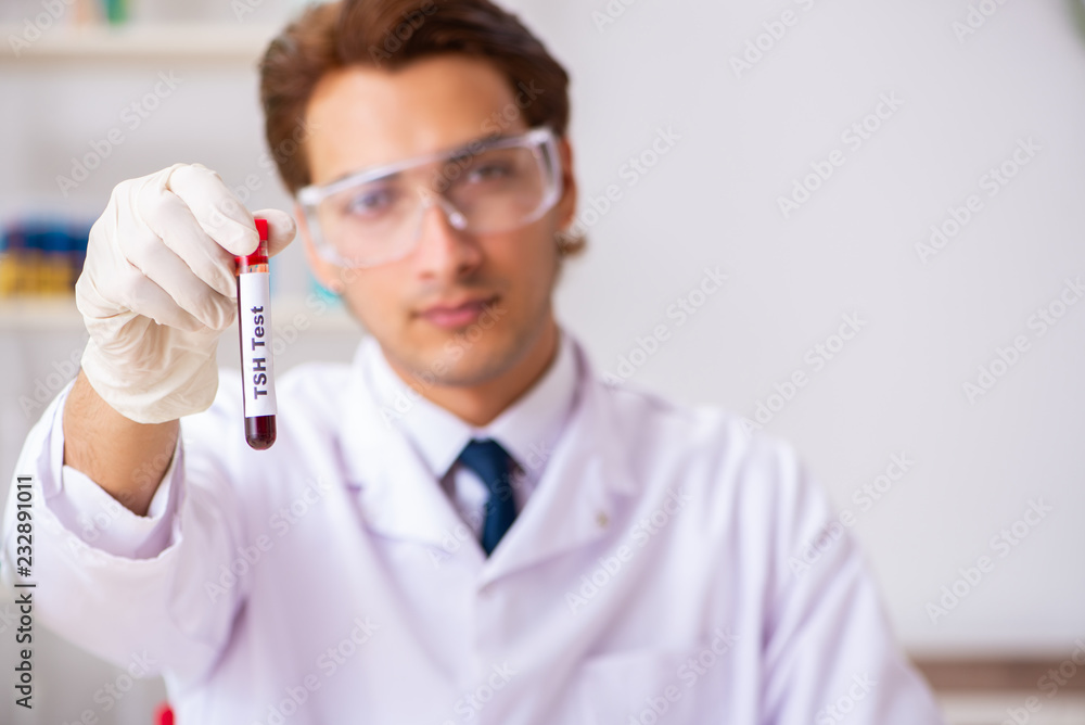 Young handsome lab assistant testing blood samples in hospital Young handsome lab assistant testing blood samples in hospital
