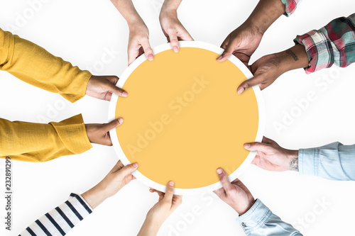 Diverse hands supporting a blank yellow round board photo