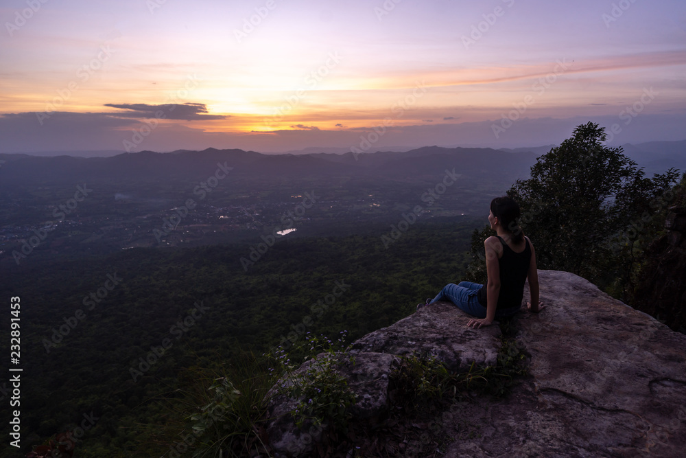 silhouette woman sitting on mountain