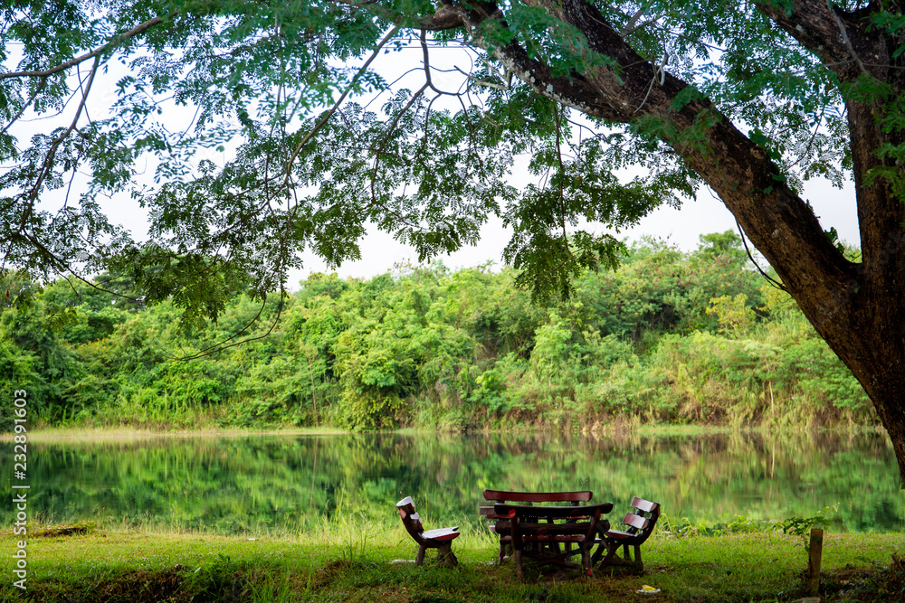 Set of garden table beside the natural lake.