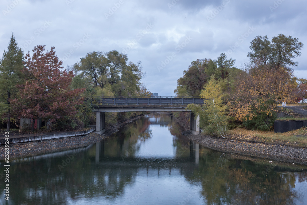 Bridge over calm river with autumn colors Bridge over calm river with autumn colors