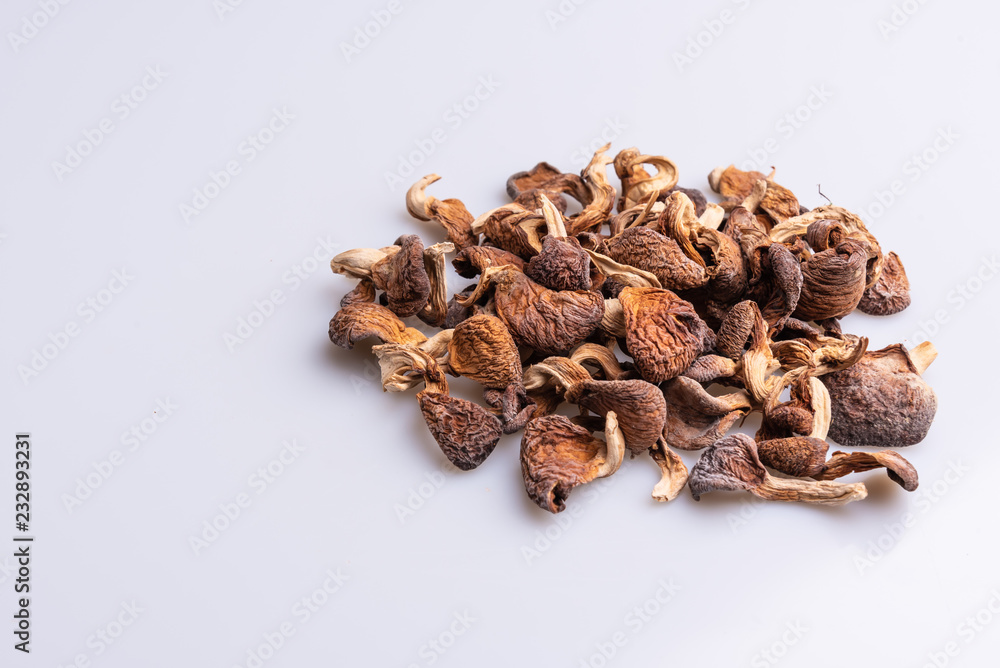 Dehydrated shimeji, dried mushrooms on white background, angle view, copy space, soft light Dehydrated shimeji, dried mushrooms on white background, angle view, copy space, soft light