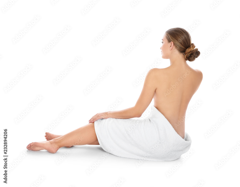 Young woman with soft towel sitting on white background Young woman with soft towel sitting on white background
