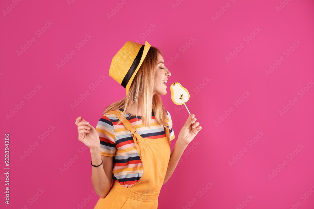 Young pretty woman with candy on colorful background - obrazy, fototapety, plakaty 
