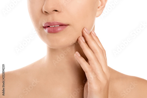 Closeup view of beautiful young woman on white background. Lips contouring, skin care and cosmetic surgery concept