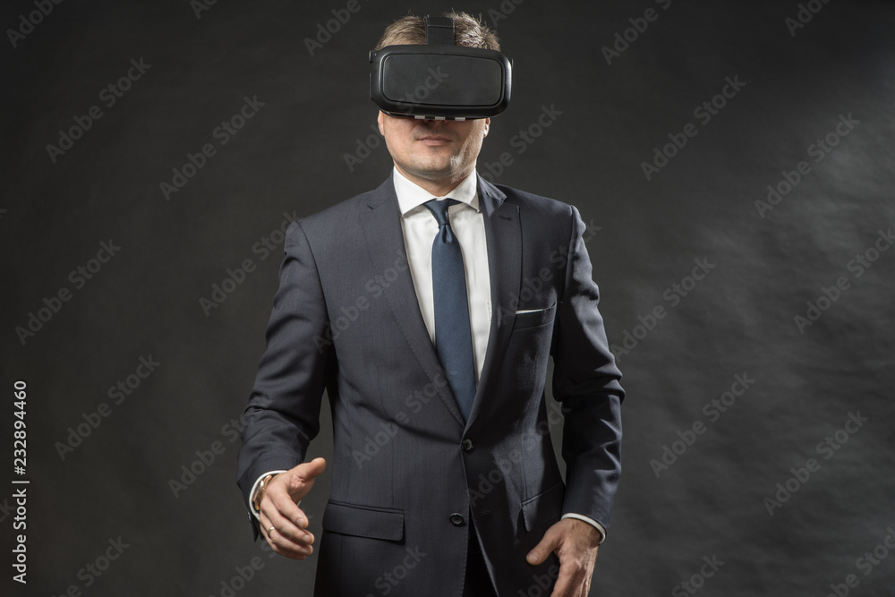 Man in black suit uses a virtual reality glasses. VR 360. Virtual game Man in black suit uses a virtual reality glasses. VR 360. Virtual game