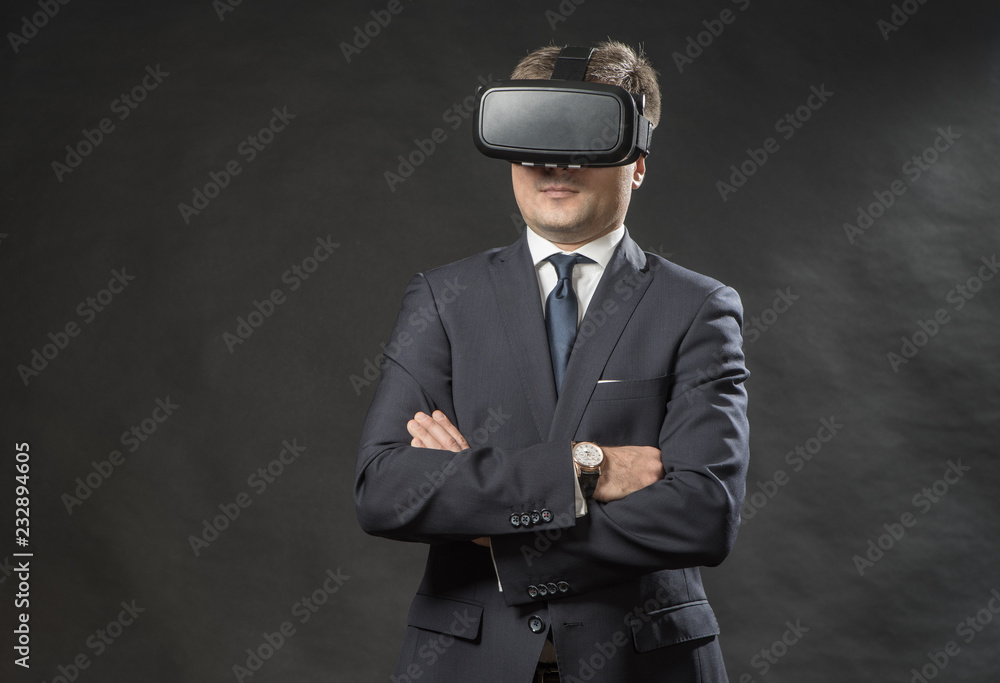 Man in black suit uses a virtual reality glasses. VR 360. Virtual game Man in black suit uses a virtual reality glasses. VR 360. Virtual game